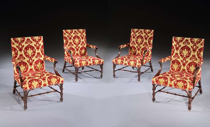 A SET OF FOUR GEORGE III MAHOGANY LIBRARY ARMCHAIRS